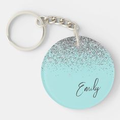 a blue and silver glitter keychain with the word alive on it's side