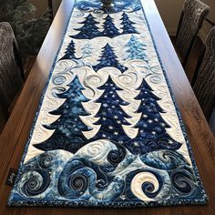 a long table runner with blue and white quilted trees on the center, in front of a dining room table