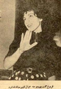 an old black and white photo of a woman with her hand up in the air