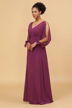 a woman in a long purple dress with an open shoulder and tie around the waist