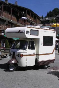 an rv parked in front of a building with the caption breaking bad on a budget