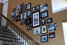 the staircase is decorated with black and white photos