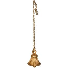 an old brass bell hanging from a chain