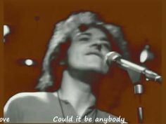 a black and white photo of a man singing into a microphone with the words love could't be anybody