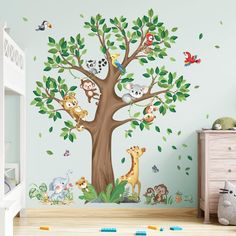 a child's room with a tree and animals on it