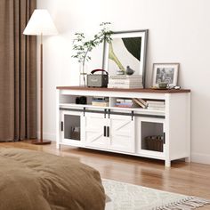 a bed sitting next to a white dresser on top of a hard wood floor