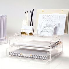 a clear desk with some pens and papers on it