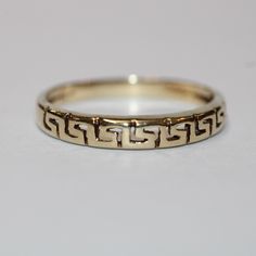 SKU: 0385 A beautiful Greek patterned  fancy ring set in 14ct yellow gold. This pretty ring would be perfect for any and every occasion. Size: UK: O American: 7 Continental: 15 This is a vintage item and such has wear. There may be some superficial scratches, otherwise the item is good condition. This item comes beautifully boxed in our own packaging. Processing time for orders is 1-3 business days. Gold Art Deco Rings With Intricate Design, Art Deco Engraved 14k Gold Round Ring, Art Deco Engraved 14k Gold Ring, Art Deco Style Engraved 14k Gold Ring, Classic 14k Gold Ring With Intricate Design, Yellow Gold Art Deco Promise Ring, Art Deco Yellow Gold Promise Ring, Vintage Yellow Gold Rings With Decorative Band, Art Deco Gold Ring For Anniversary