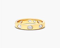 14K Yellow Gold Bezel Set Oval Diamond Ring. The smoothness of the metal is highlighted by the sparkle of the diamonds. Wear it alone or up the sparkle by pairing it with multiple stackable rings. Luxury Oval Stackable Rings, Oval Diamond Stackable Rings With Diamond Accents, Luxury Oval Stackable Diamond Ring, Luxury Oval Yellow Gold Stackable Rings, Luxury Yellow Gold Oval Stackable Rings, Gold Oval Diamond Stackable Rings, Oval Stackable Rings With Rose Cut Diamonds For Anniversary, Oval Gold Diamond Stackable Rings, Brilliant Cut Diamond Stackable Oval Rings