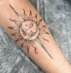 a sun tattoo on the arm with a knife in it's center and face