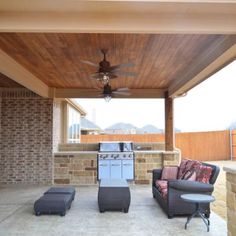 an outdoor living area with furniture and a grill