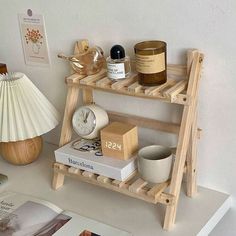 a shelf that has some books and candles on it