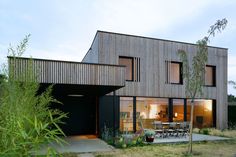 the house is made out of wood and has large windows