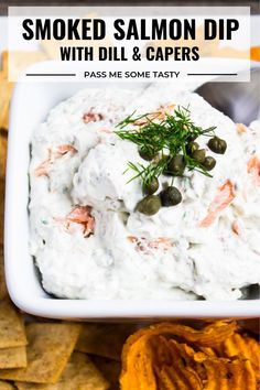 smoked salmon dip with dill and capers in a white bowl surrounded by chips