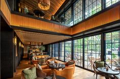 the inside of a restaurant with lots of tables and chairs in front of large windows