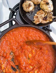 two pans filled with food sitting on top of a stove next to each other