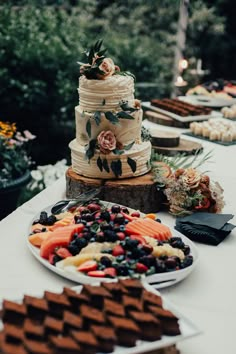 a table topped with lots of cakes and desserts