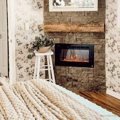 a fireplace in a bedroom with a blanket on the floor