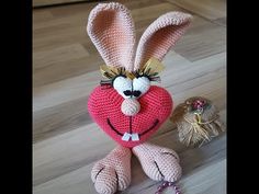 a crocheted stuffed animal sitting on top of a wooden floor