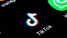 the tiktok logo is displayed on an iphone