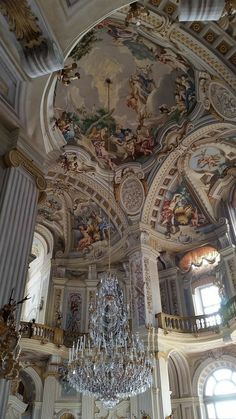 a chandelier hanging from the ceiling in a large room