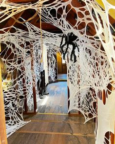 the inside of a building with spider webs hanging from it's ceiling and wood floors