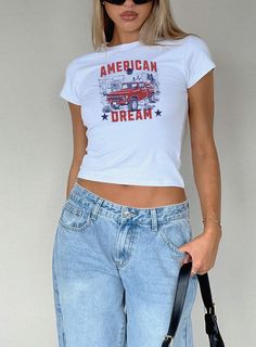 Looking for the perfect fitting 4th of July American Dream Baby Tee? Our comfortable and trendy baby tees are perfect for yourself or as a gift!   SIZING -This is a "youth" Gildan 5000B t shirt -Please review the size chart to ensure you order the correct size -Model is wearing (in order) a size S in white, S in light blue, XS in light pink, M in sports grey, XS in white -These shirts reflect the vintage 90's baby tee fit and hit at hip length. They may fit looser around the waist and are not de White Baby Tee Outfit, 4th Of July Streetwear Graphic Tee, Baby Tees Outfit, White Americana Style Summer T-shirt, Ahs Clothes, Frat Party Themes, Casual 4th Of July Streetwear T-shirt, Casual Fitted T-shirt For 4th Of July, Fitted Casual T-shirt For 4th Of July