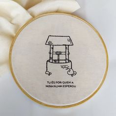 a white cloth with a drawing of a small house on it's front and side