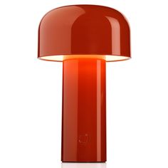 an orange table lamp with a white light on the top and bottom part of it