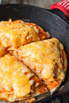 cheese covered pizza in a cast iron skillet