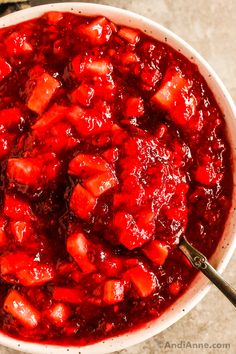 a white bowl filled with cranberry sauce on top of a table