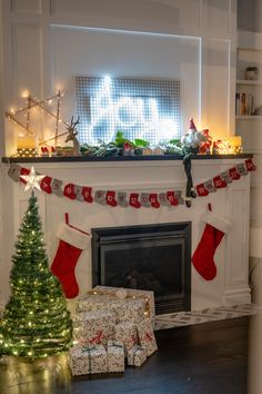 a fireplace decorated for christmas with stockings and presents