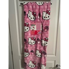 a hello kitty towel hanging on a door