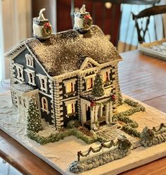 a gingerbread house decorated for christmas on a table