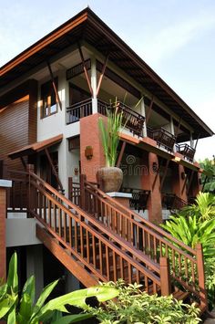 a large house with wooden stairs leading up to it