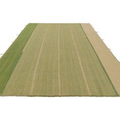 an aerial view of a green field with rows of grass on each side and one row of crops in the middle