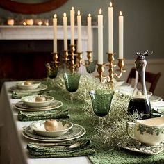 the table is set with candles and dishes