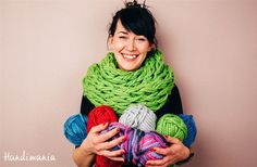 a woman is smiling while holding two balls of yarn in front of her and another photo of the same knitting project