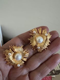 The Victorian studs are handcrafted in brass and gold polish with beautiful pearls embedded on a statement gold base. Pick this gorgeous pair and make a stunning statement! Shine away at your next special event The diameter is 3 inches approximately. Push back closure. Gold Studded Earrings, Gold-plated Bridal Earrings For Party, Gold Plated Bridal Earrings For Party, Gold Plated Metal Pearl Earrings, Chic Gold Clip-on Earrings With Pearl Drop, Gold Elegant Pearl Earrings, Glamorous Gold-plated Bridal Earrings, Gold Brass Pearl Earrings For Wedding, Chic Gold Bridal Earrings For Party