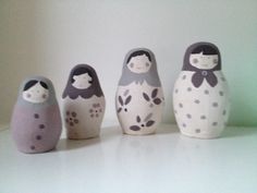 five small nesting dolls sitting on top of a table