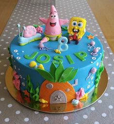 the birthday cake is decorated with spongebob characters