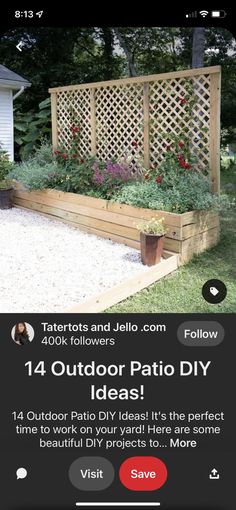 an outdoor patio with flowers and plants on the back yard, next to a wooden trellis