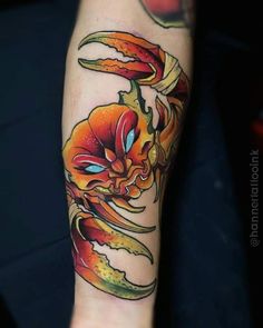 a colorful tattoo on the arm of a person with an orange and yellow flower in it