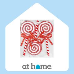 two red and white lollipops in a package with the logo at home