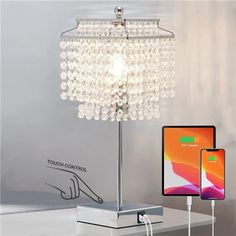 a table lamp that is next to an iphone