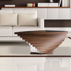 a living room with a white couch and wooden table in front of bookshelves