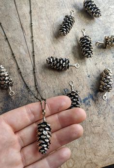 I live in upstate NY, and pinecones are everywhere🌲 The main purpose of a pinecone is to keep the seeds of the tree safe, which is why it is shaped with it's scales closely in and down. As with most things in nature, they're beautiful and perfectly designed This pendant is made out of antique brass and copper. Up close, it's very realistic looking and larger than the other designs I've seen on Etsy. The pendant measures about 2 inches in height and looks amazing on a long chain so you can fidge Three Pines Gifts, Pine Cones Jewelry, Silver Pines Gifts, Necklaces For Nature, Real Pinecone Earrings, Pine Needle Ring, Pine Cone Necklace, Pine Cone Jewelry, Things In Nature