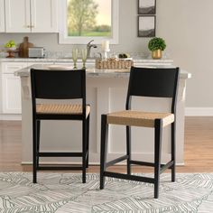 two chairs sitting on top of a rug in a kitchen next to a countertop