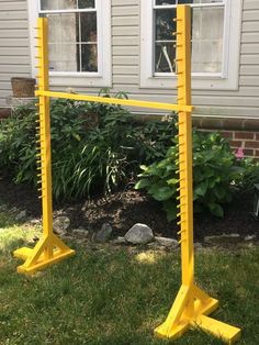 a yellow frame stands in front of a house