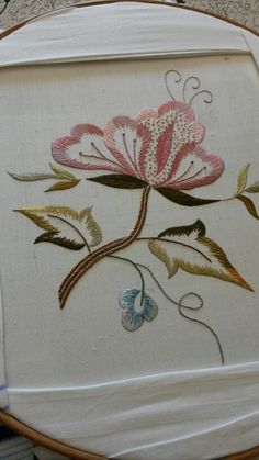 an embroidered piece of cloth with flowers on it